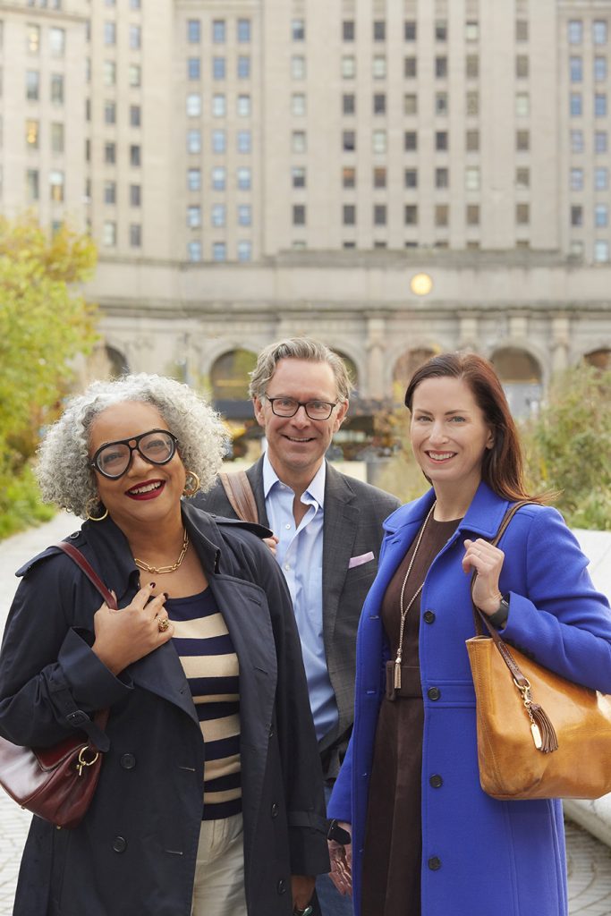 three business professional individuals smiling