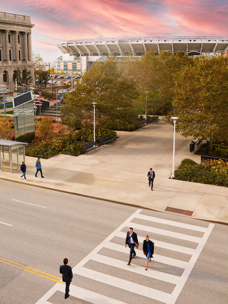 people walking across the street near cleveland browns stadium